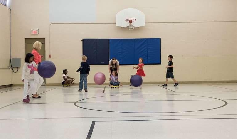 Kids playing with balls in the gym